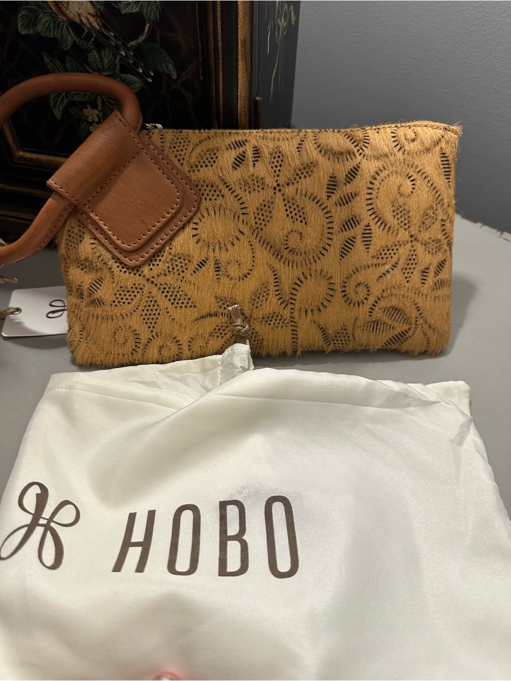 HOBO sable wristlet in wheat with hair on.